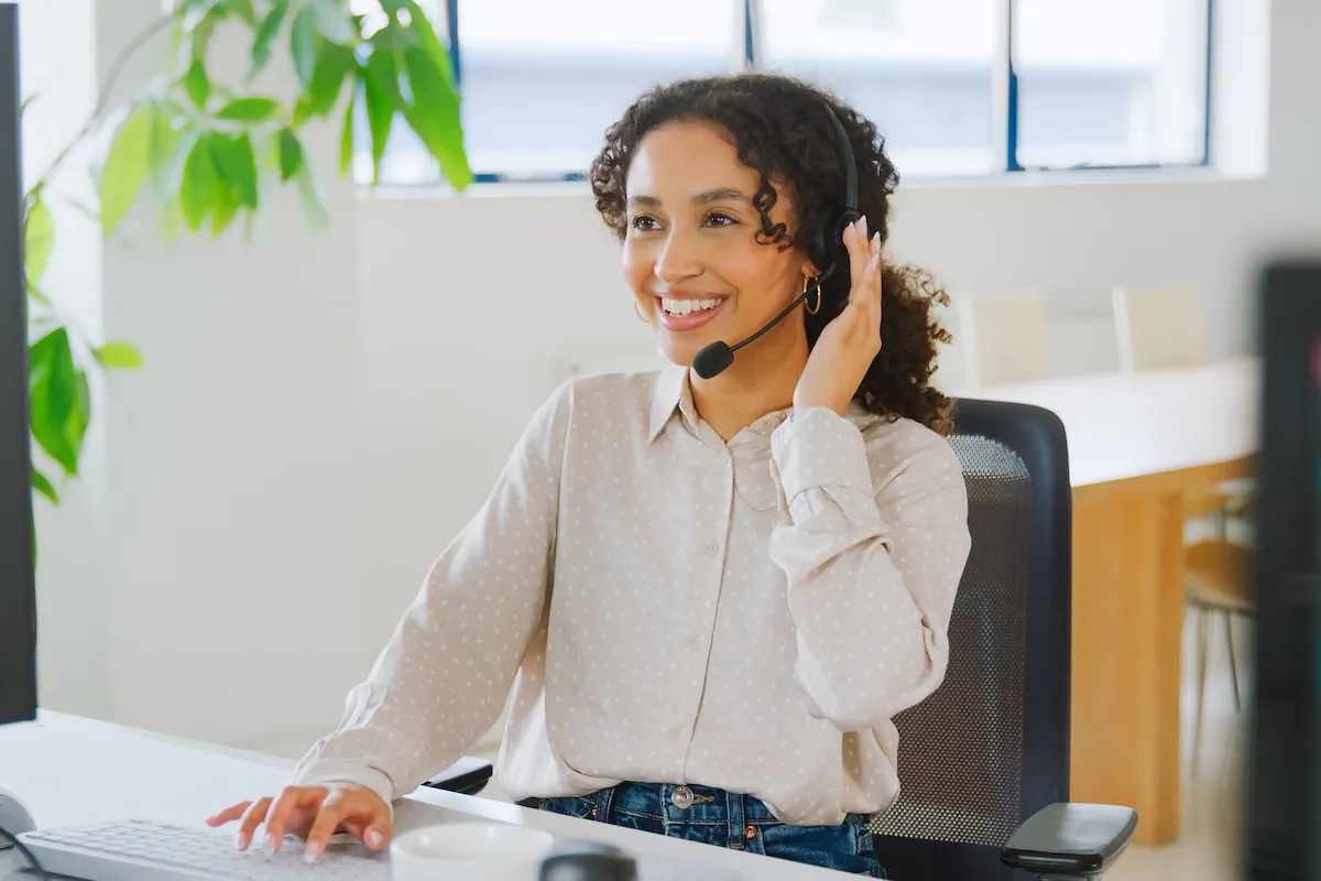 woman-wearing-headset-sitting-at-desk-working-in-o-2026-01-09-12-42-08-utc-1200x800